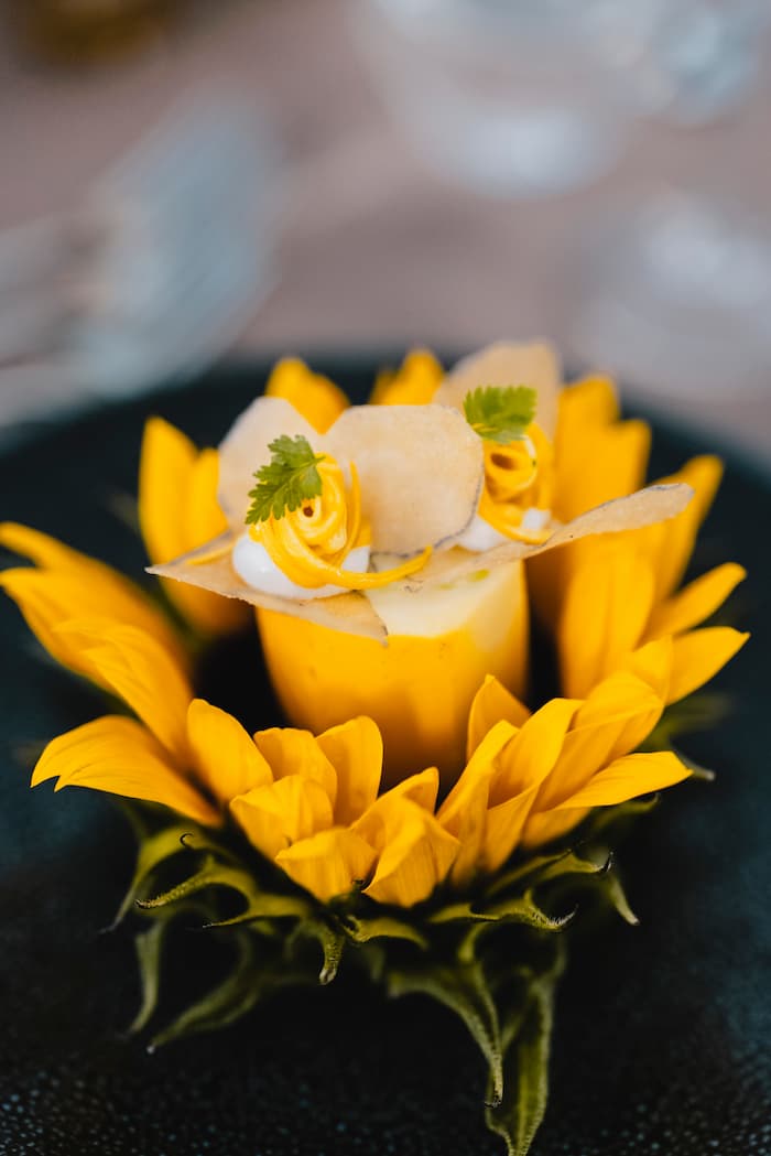 Portrait view of restaurant interior: elegant dining setup with warm lighting, showcasing the intimate atmosphere of Atelier Gourmet.