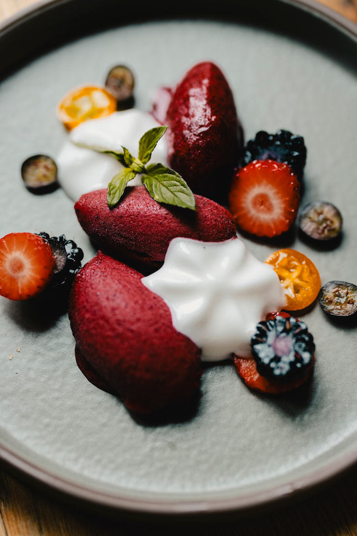 Vertical perspective of Atelier Gourmet's dining experience: elegant table setup with premium glassware and refined culinary presentation.